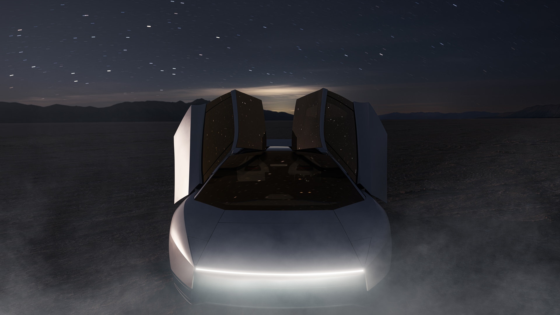 Futuristisk silvrig bil sedd framifrån med öppna dörrar som pekar uppåt, på en torr öken under stjärnhimmel.