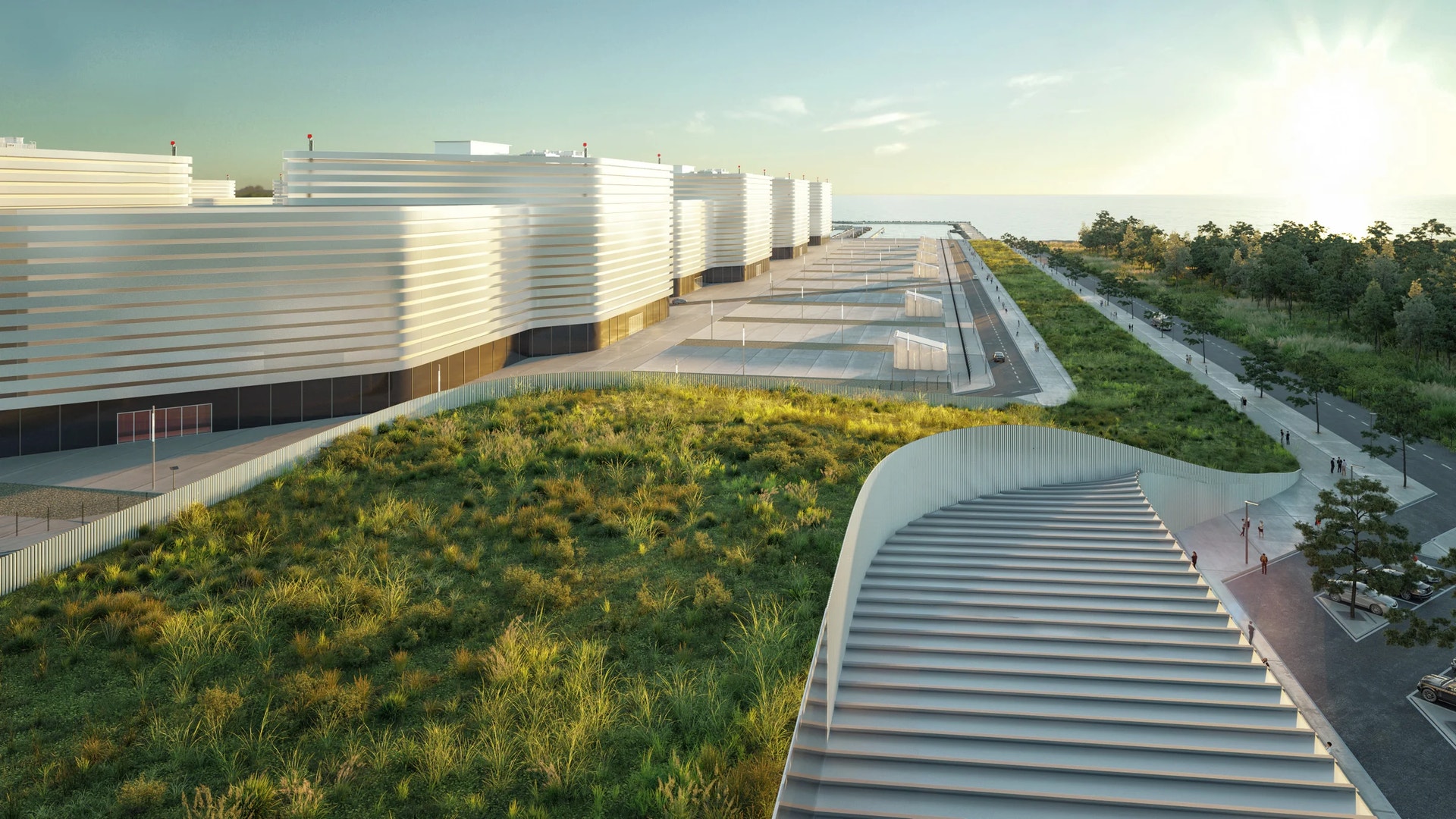 Modernt arkitekturkomplex med gröna tak och metallklädda byggnader under molnig himmel.