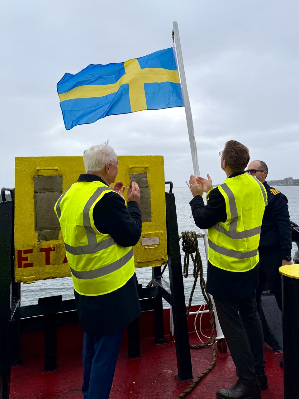 Dan Sten Olsson och Andreas Carlsson hissar svensk flagg