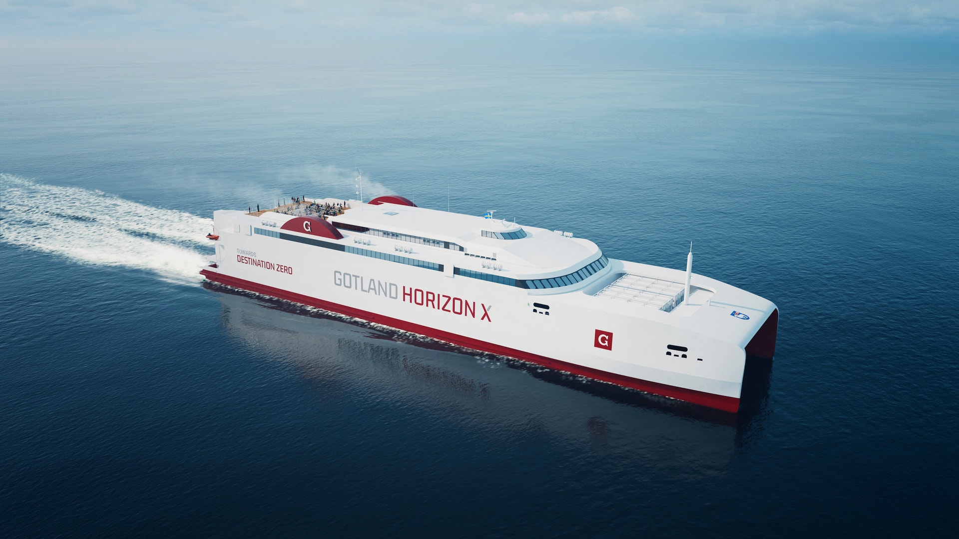Passagerarfartyget Gotland Horizon X färdas genom öppet blått hav. Fartyget är vitt med röda detaljer och skapar ett skumvak bakom sig.