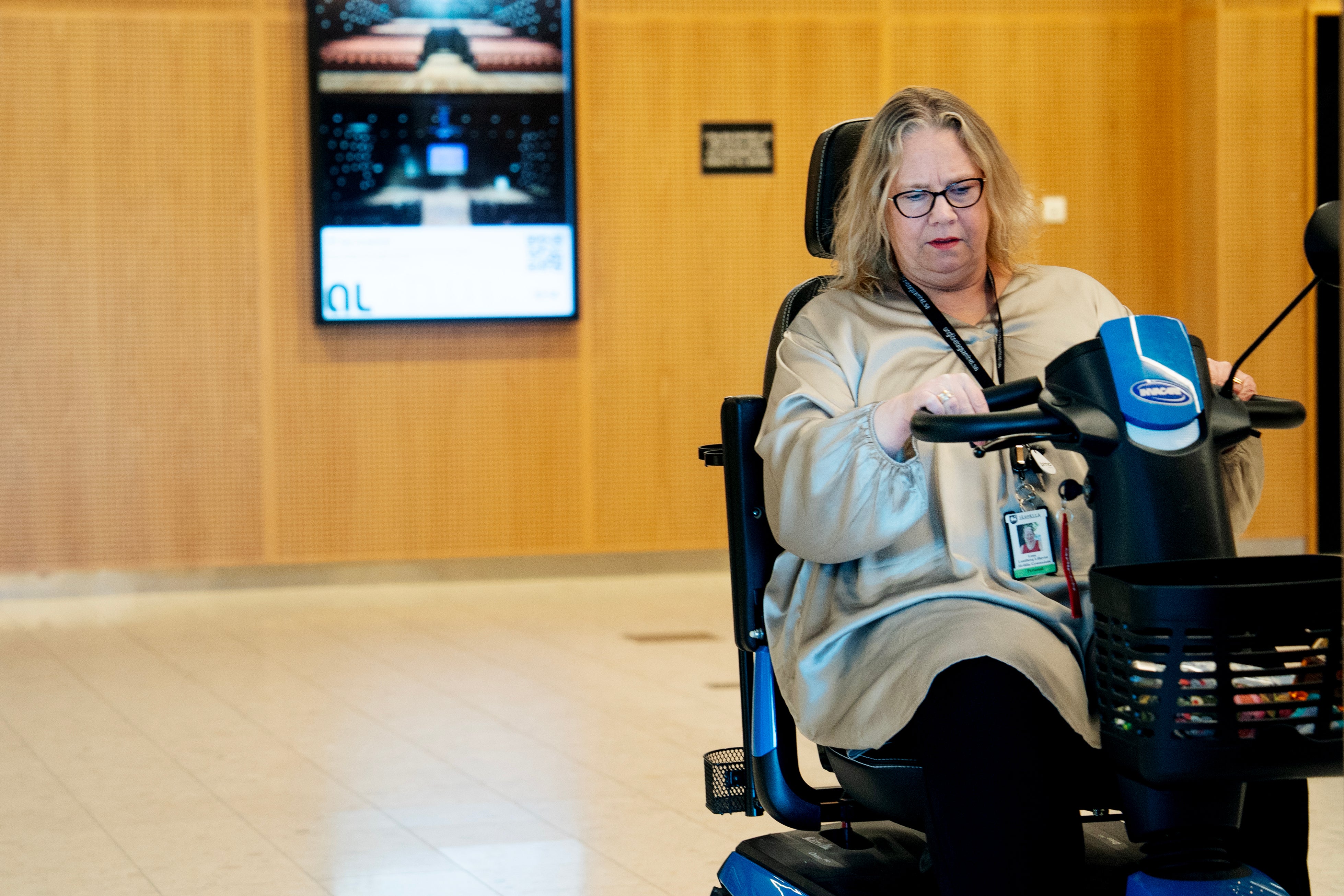 Kvinna som sitter framför en mikrofon i en studiomiljö och talar in i den.