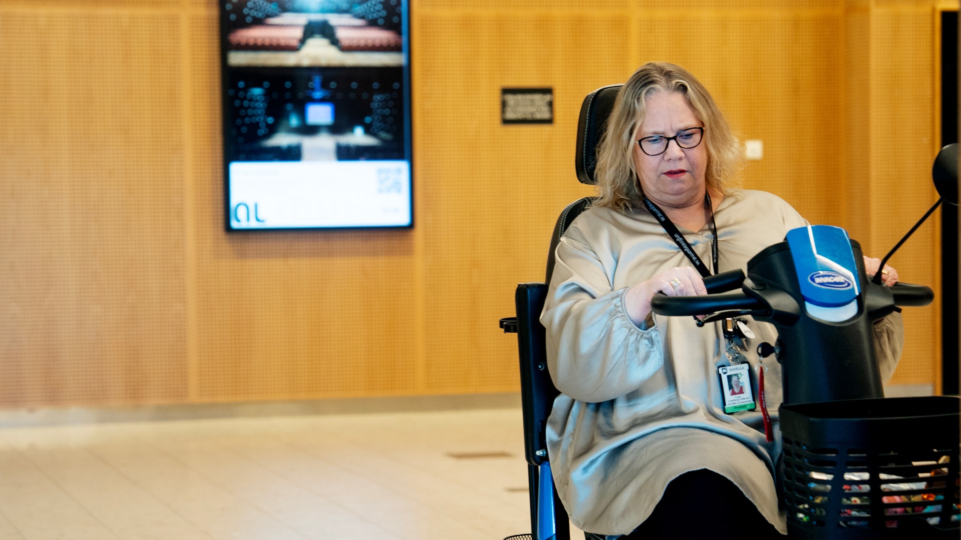 Kvinna som sitter framför en mikrofon i en studiomiljö och talar in i den.