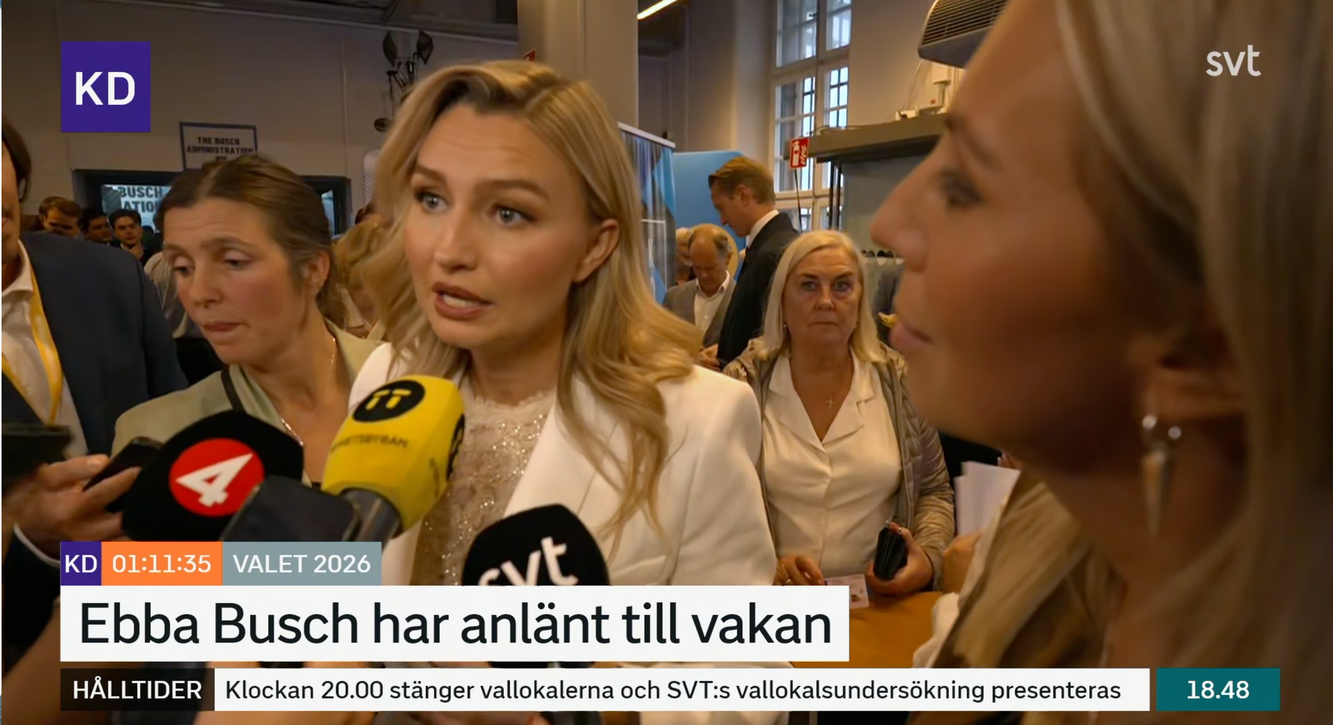 Ebba Busch intervjuas av journalister med mikrofoner under en valvaka.