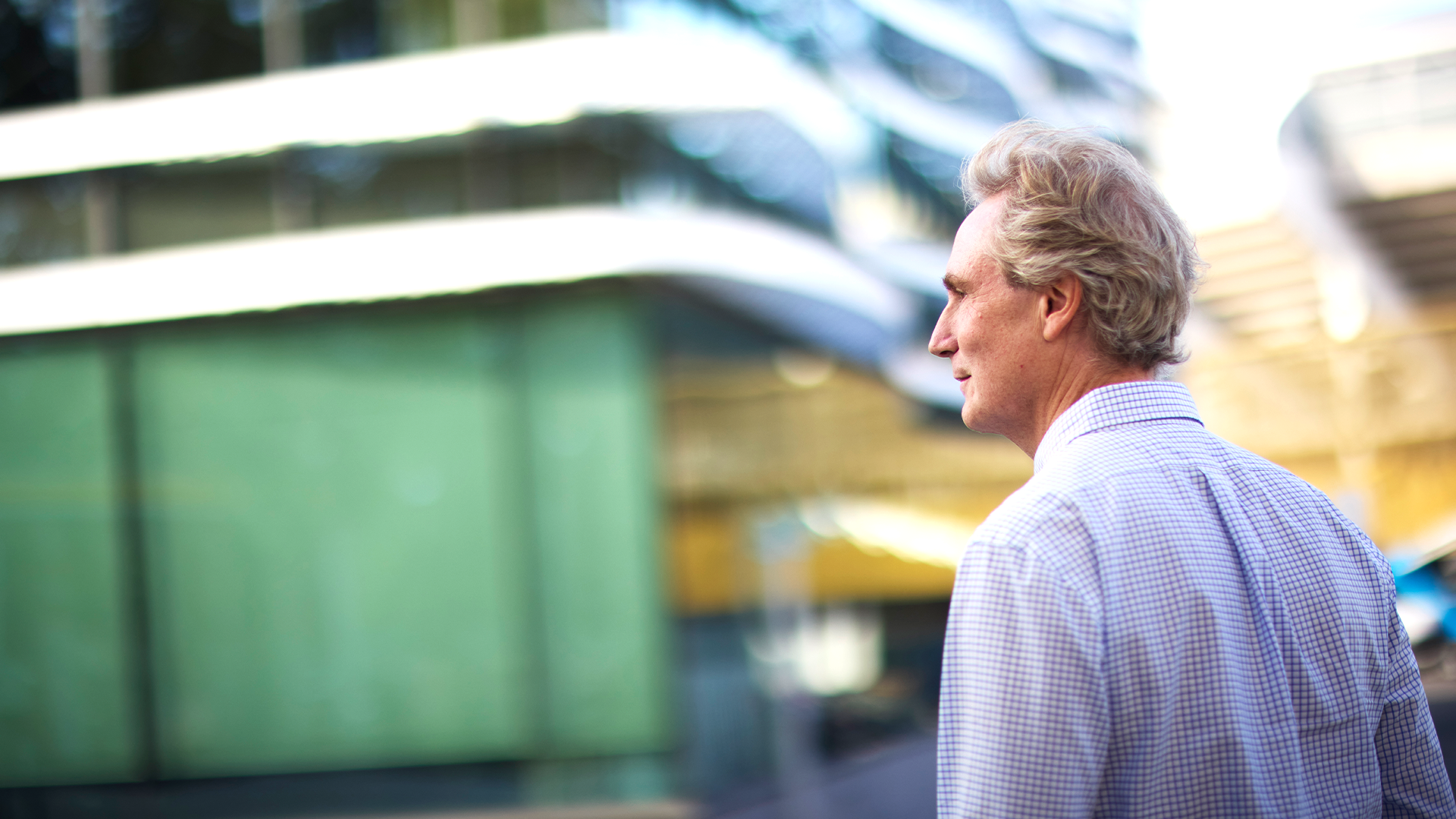 Erik Selin traskar på gatan utanför Balders kontor i Göteborg. Han har blå-vit rutig skjorta. 