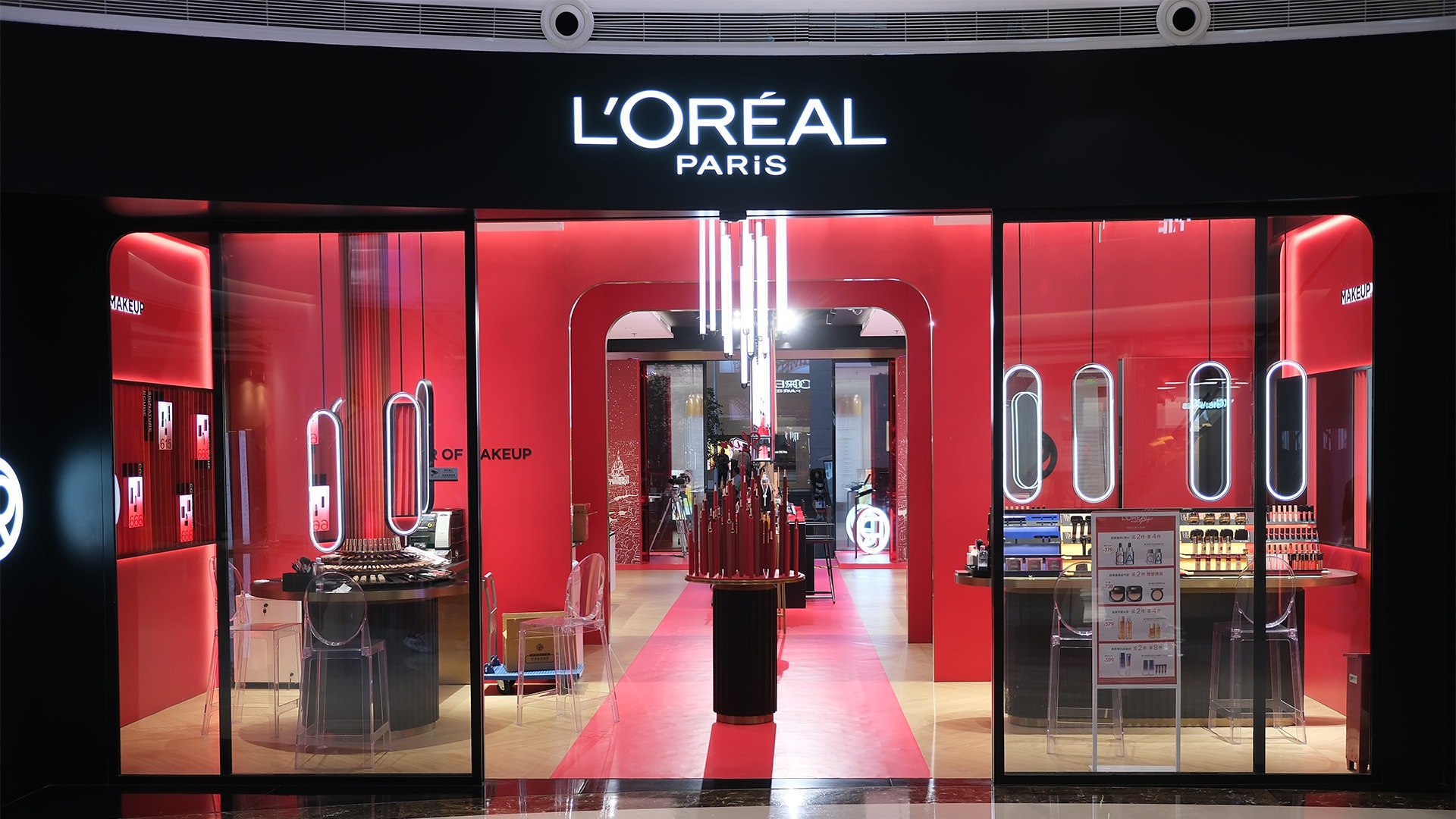 Entrén till en L'Oréal Paris-butik med röd inredning och skyltfönster med smink.