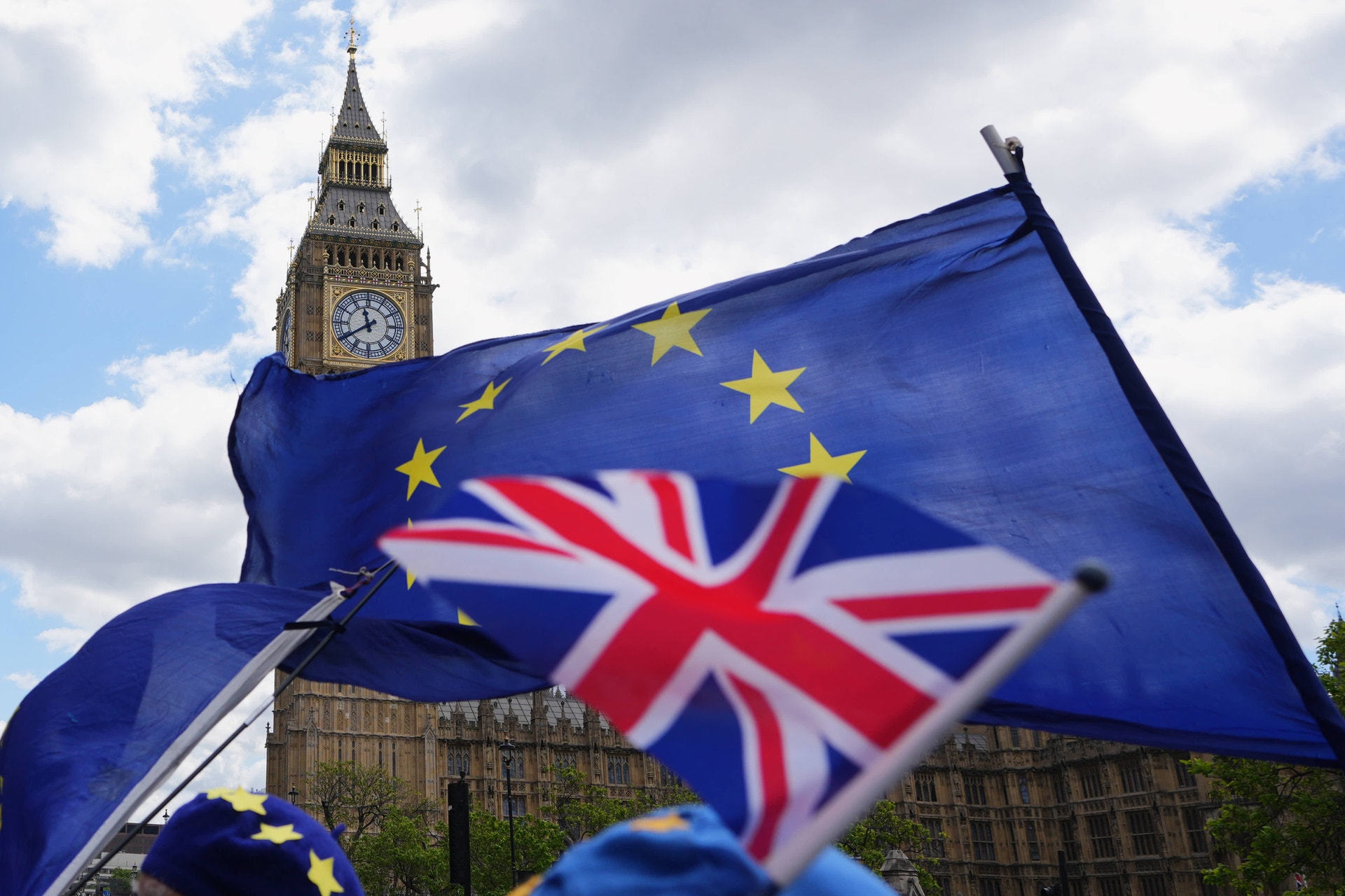 EU-flaggor och brittisk flagga framför Big Ben i London, symboliserande Brexit och förhållandet mellan Storbritannien och Europeiska unionen.